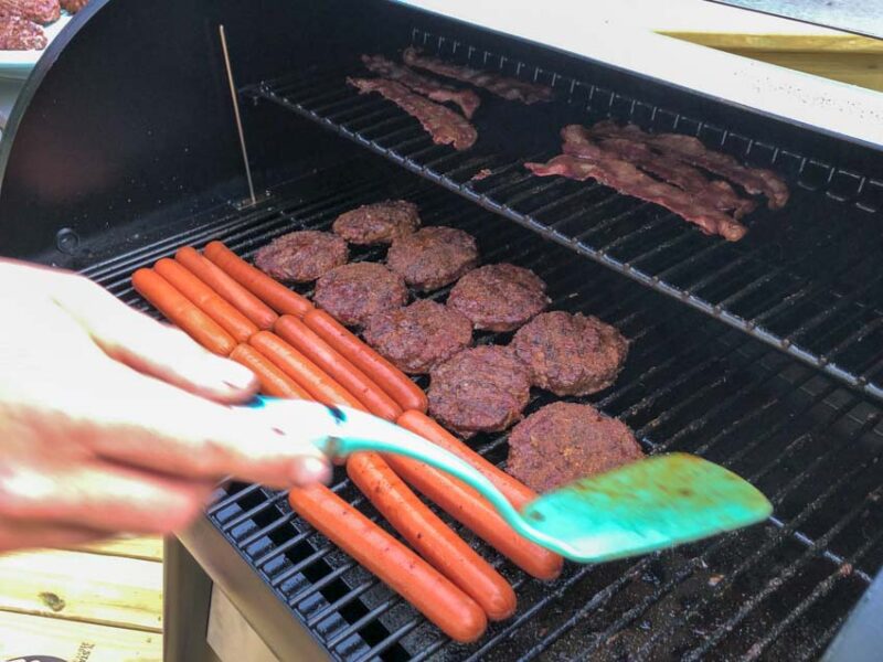 smoking burgers hot dogs grill