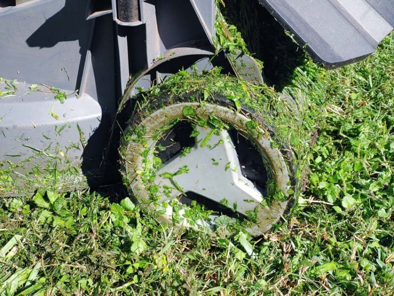 mower wheels caked with wet grass